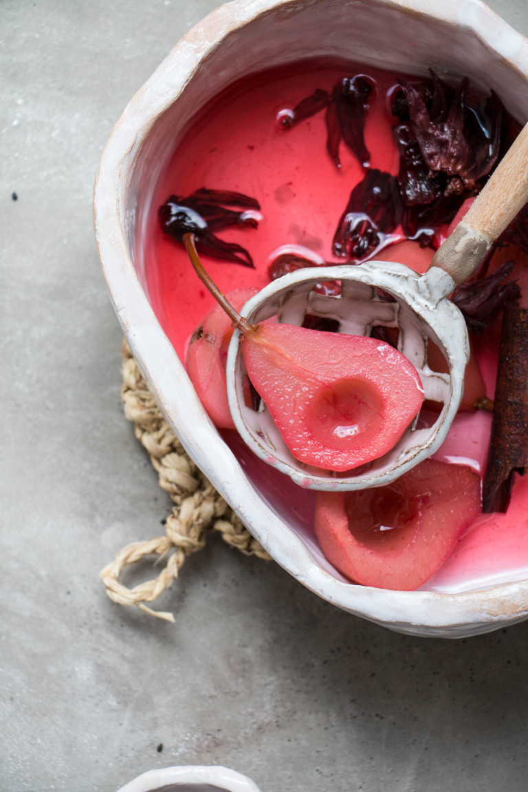 Spiced Hibiscus Poached Pears In Rose Black Sesame Meringue Nests