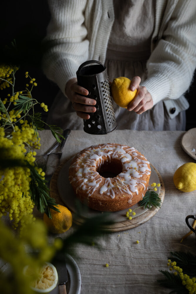 grating lemon on cake